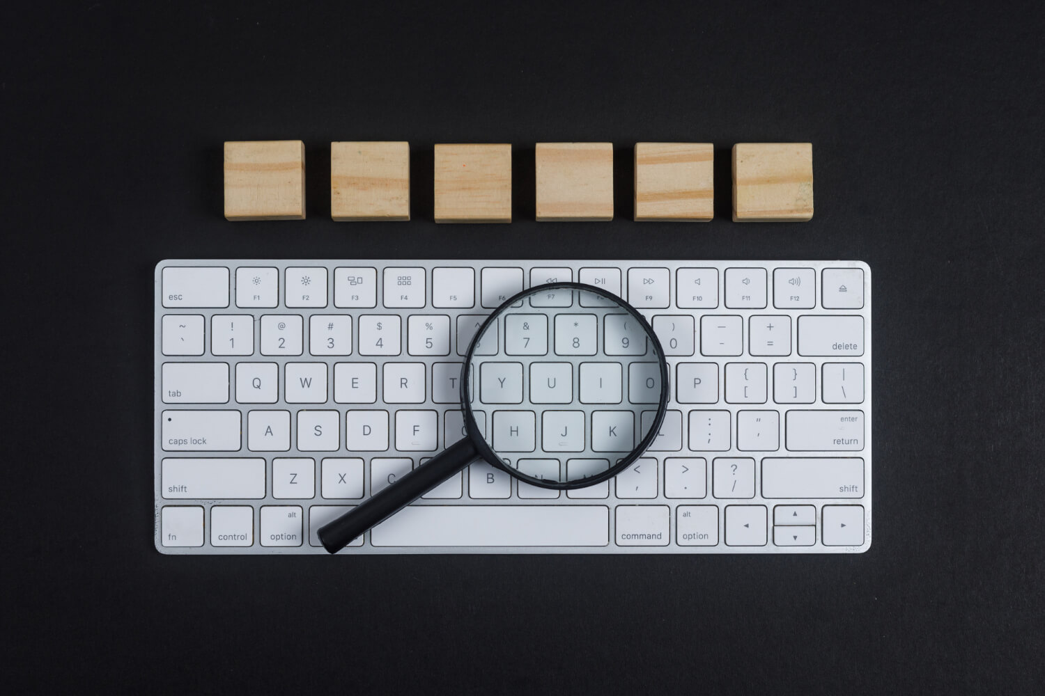 conceptual-research-with-keyboard-magnifier-wooden-cubes-black-desk-background-flat-lay-horizontal-image